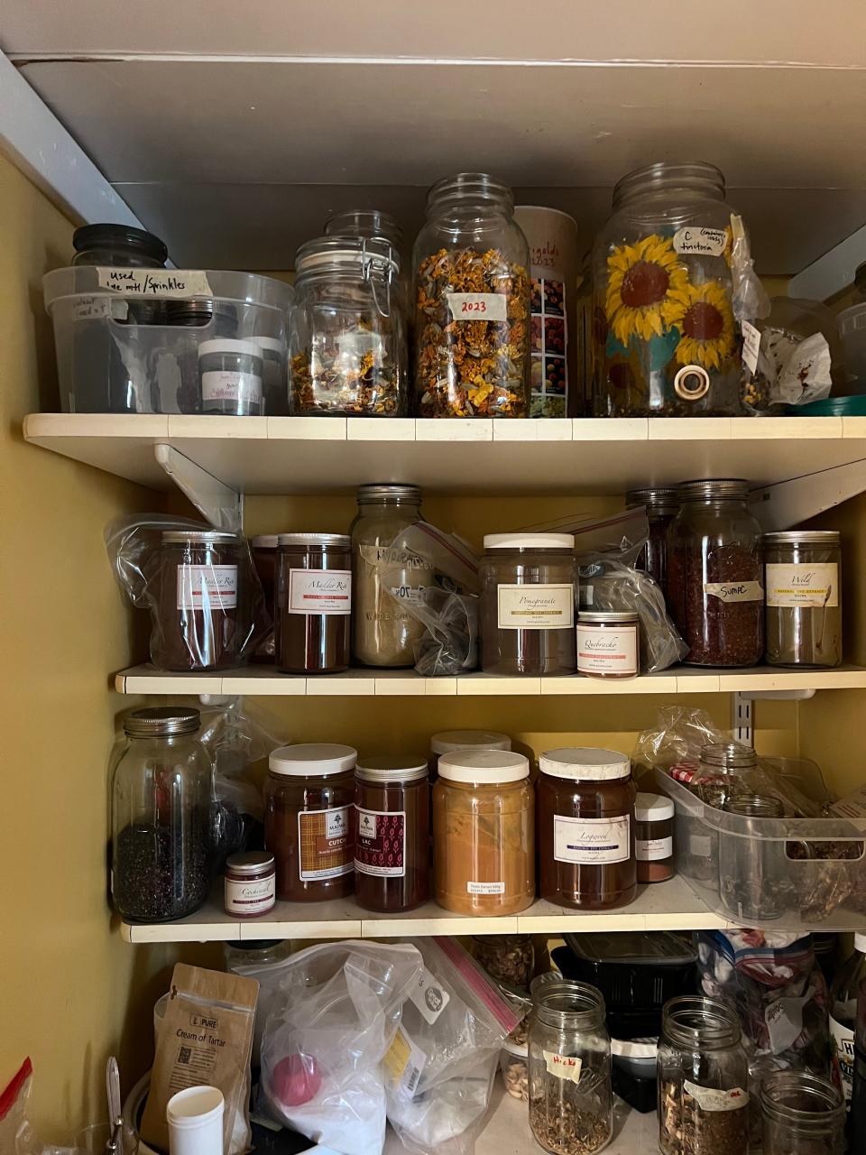 Michelle Saylers and Linda Williams keep all of their seeds, dried fruits and vegetables, and sawdust in a cabinet. The best way to reduce waste is to keep reusing their products, which is what Michelle and Linda have always done since they started using natural dyes during the COVID-19 pandemic.