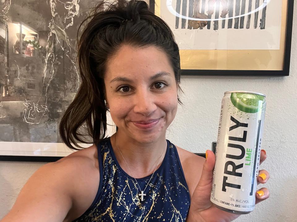 chelsea holding a can of lime truly hard seltzer