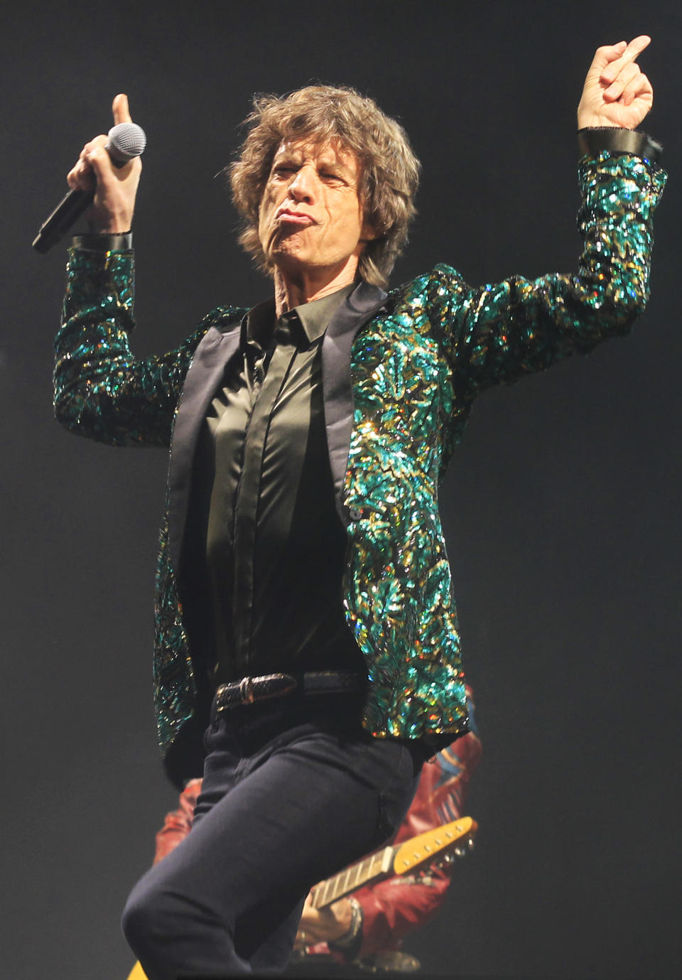 FILE - Mick Jagger of The Rolling Stones performs in Glastonbury, England on June 29, 2013. Jagger's jacket is among 55 L'Wren Scott creations going on sale this week at Christie’s in London. (Photo by Jim Ross/Invision/AP, File)