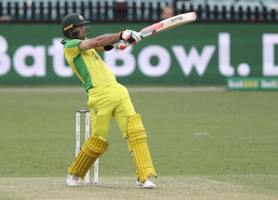 Australia's Glenn Maxwell hits the ball for six runs during the one day international cricket match between India and Australia at the Sydney Cricket Ground in Sydney, Australia, Sunday, Nov. 29, 2020. (AP Photo/Rick Rycroft)