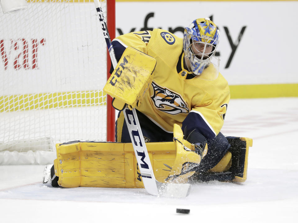 Nashville Predators goaltender Juuse Saros, of Finland, stops a shot by the Pittsburgh Penguins during the third period of an NHL hockey game Friday, Dec. 27, 2019, in Nashville, Tenn. The Penguins won 5-2. (AP Photo/Mark Humphrey)