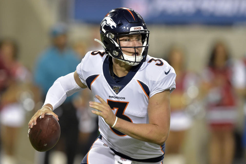 FILE - In this Aug. 1, 2019, file photo, Denver Broncos quarterback Drew Lock scrambles during the second half of the Pro Football Hall of Fame NFL preseason game against the Atlanta Falcons in Canton, Ohio. The Broncos are increasing rookie quarterback Drew Lock’s workload at practice this week to determine if he should get his first NFL start against the Chargers this weekend. (AP Photo/David Richard, File)