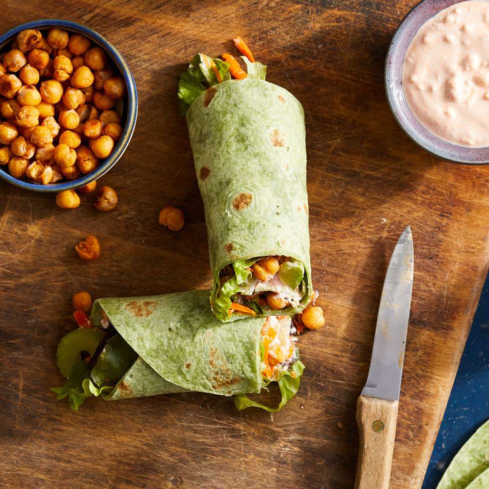 <p>This vegetarian riff on a Buffalo chicken wrap adds the spicy Buffalo tang you love to crunchy roasted chickpeas all tucked into an easy-to-make wrap with carrot, celery and blue cheese. Make and take a wrap for a healthy packable lunch or serve them up on game day for a protein-packed snack everyone will devour.</p> <p> <a href="https://www.eatingwell.com/recipe/261765/roasted-buffalo-chickpea-wraps/" rel="nofollow noopener" target="_blank" data-ylk="slk:View Recipe;elm:context_link;itc:0;sec:content-canvas" class="link ">View Recipe</a></p>