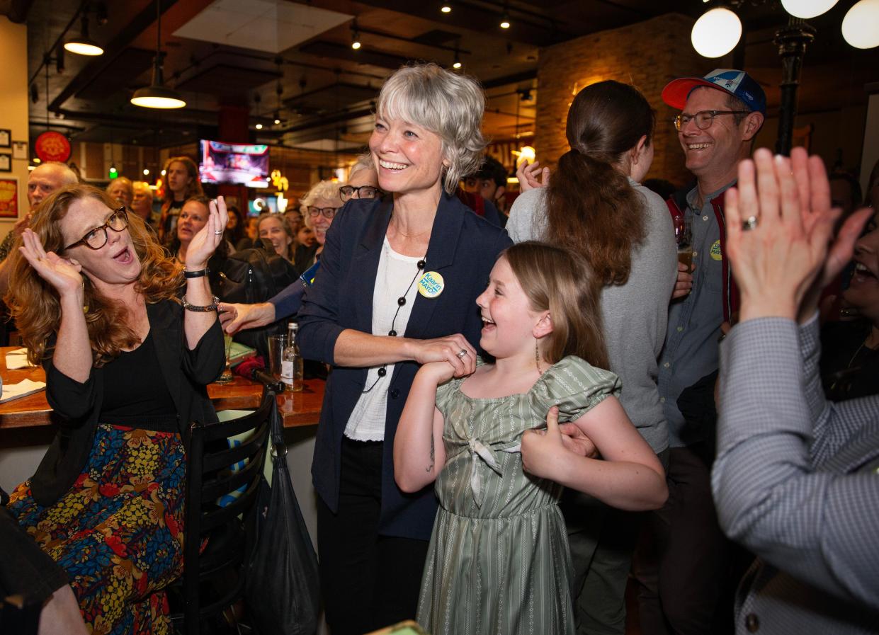 Eugene Mayor candidate Kaarin Knudson, center, celebrates with family and supporters as early returns show her leading the race for mayor during a watch party at The Bier Stein in Eugene.