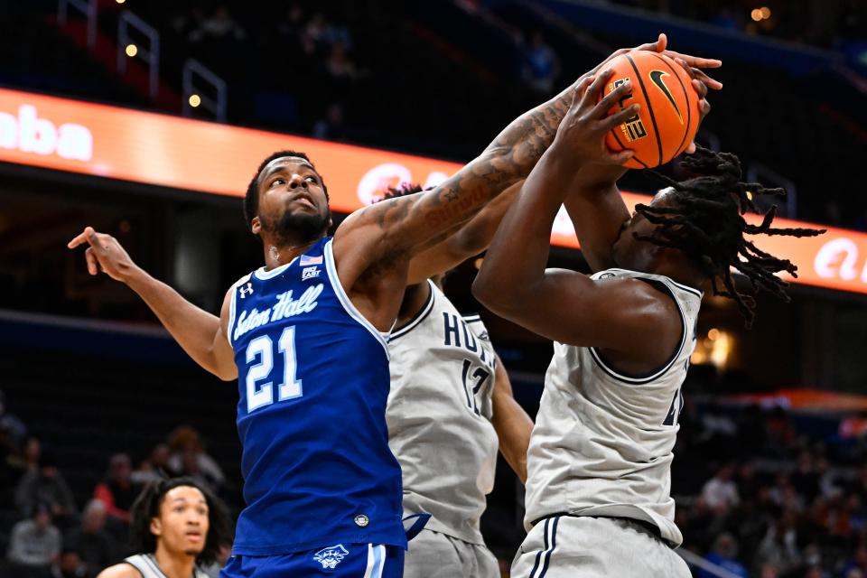 Georgetown Hoyas forward Bradley Ezewiro (22) grabs a rebound from Seton Hall Pirates guard Femi Odukale (21) during the first half at Capital One Arena.