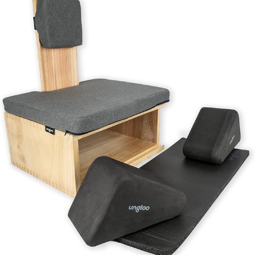 light wood meditation bench, black cushion and mat against white background