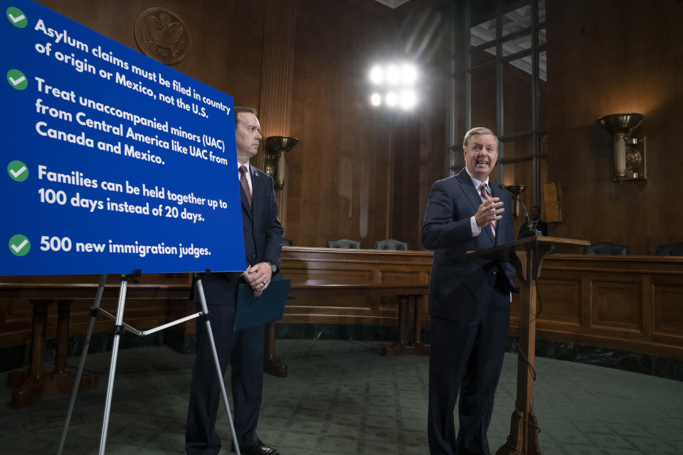 Senate Judiciary Committee Chairman Lindsey Graham, R-S.C., an ally of President Donald Trump, is joined by Acting U.S. Customs and Border Protection Commissioner John Sanders, left, as he announces his proposal to revamp laws that affect the increase of Central American migrants seeking asylum to enter the U.S., on Capitol Hill in Washington, Wednesday, May 15, 2019. (AP Photo/J. Scott Applewhite)