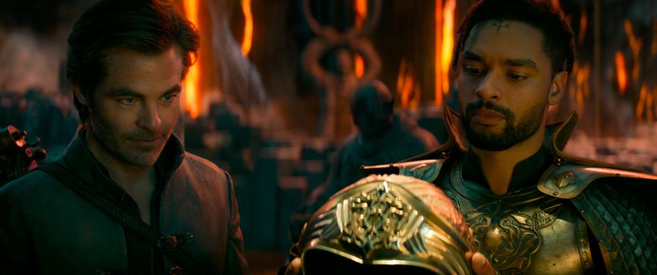 Edgin (Chris Pine, left) and Xenk (Regé-Jean Page) check out a fancy helmet in "Dungeons & Dragons: Honor Among Thieves."