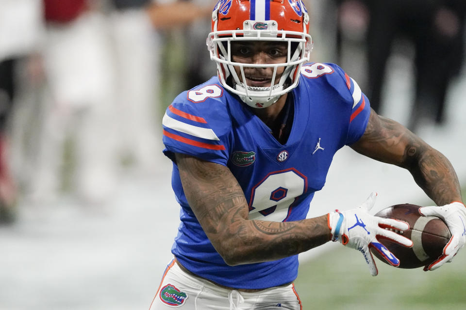 Florida wide receiver Trevon Grimes (8) runs for a touchdown after a catch against Alabama during the second half of the Southeastern Conference championship NCAA college football game, Saturday, Dec. 19, 2020, in Atlanta. (AP Photo/John Bazemore)