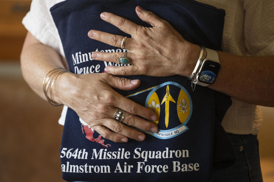 Doreen Jenness, the widow of Air Force Capt. Jason Jenness, clutches one of Jason's sweatshirts during an interview with the Associated Press in Missoula, Mont., Aug. 26, 2023. Capt. Jenness was a Malmstrom missileer who died of non-Hodgkin lymphoma in 2001 at the age of 31.(AP Photo/Tommy Martino)