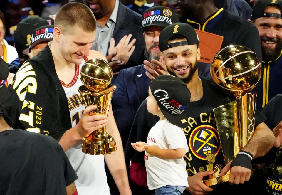 Game 5: Nikola Jokic celebrates with the Bill Russell NBA Finals MVP Award.