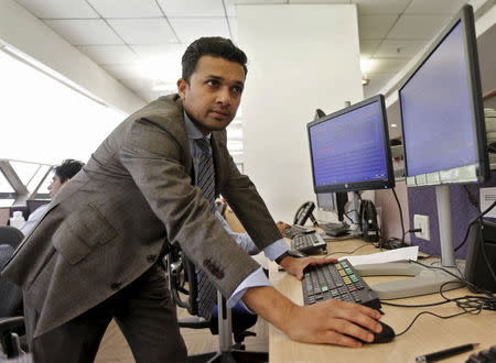 Yatin Shah, executive director of IIFL Private Wealth Management, works on a terminal in the dealing room at the IIFL centre in Mumbai, August 31, 2015. REUTERS/Shailesh Andrade