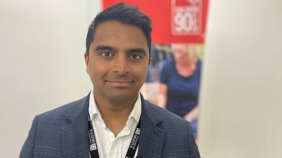 Man in suit looks at camera