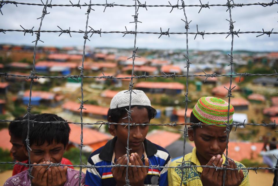 Rohingya refugees pray at a ceremony to remember the first anniversary of a military crackdown that prompted a massive exodus of people from Myanmar to Bangladesh, at the Kutupalong refugee camp in Ukhia on Aug. 25, 2018.