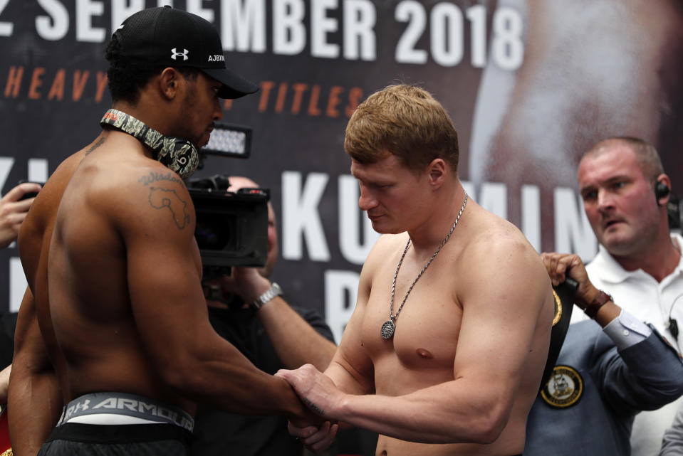 Britain's Anthony Joshua, left, and Russia's Alexander Povetkin, right, shake hands during the weigh-in at the Business Design Centre in London, Friday, Sept. 21, 2018. Anthony Joshua and Alexander Povetkin are due to fight for the WBA, IBF, WBO and IBO heavyweight title in a boxing match on Saturday, Sept. 22 at Wembley stadium. (AP Photo/Frank Augstein)