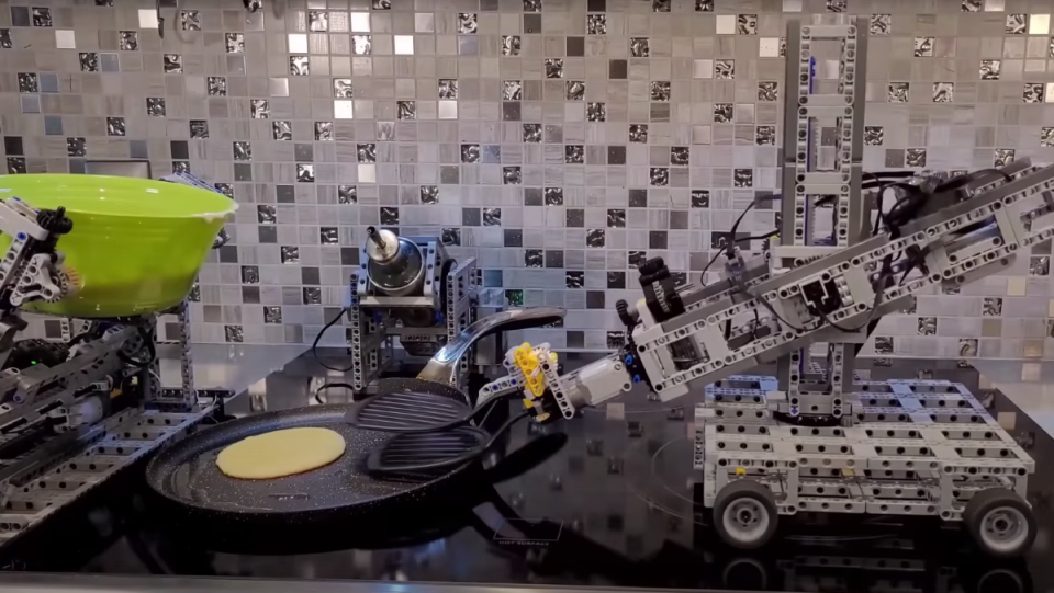 LEGO Technic builds pour oil and pancake batter onto a pan and flip them as they cook