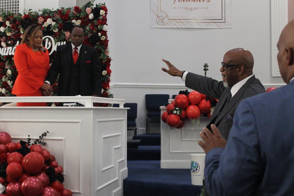 Bishop Gary L. Hall Sr., right, prays over Senior Pastors George B. Dix Jr. and Lady Michele Dix, left, during the Founders' Day service at the church in NE Gainesville on Sunday. The Dix's founded the church 21 years ago.
(Credit: Photo by Voleer Thomas/For The Guardian)