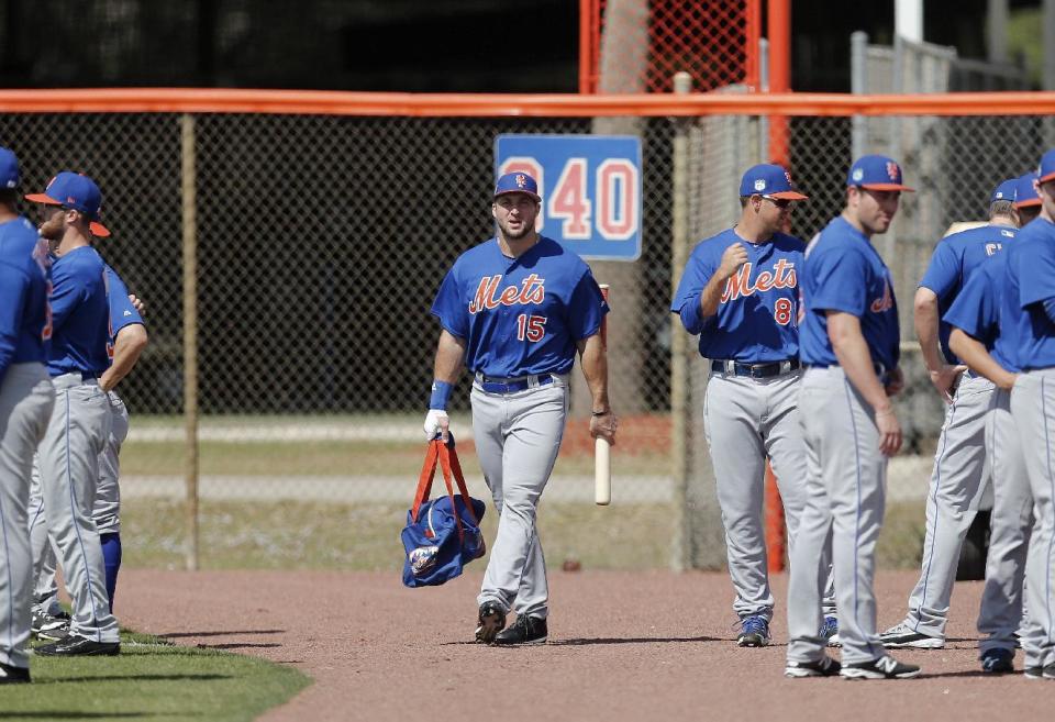 Former NFL quarterback and New York Mets outfielder Tim Tebow carries his equipment bag to a spring training baseball practice Monday, Feb. 27, 2017, in Port St. Lucie, Fla. (AP Photo/John Bazemore)