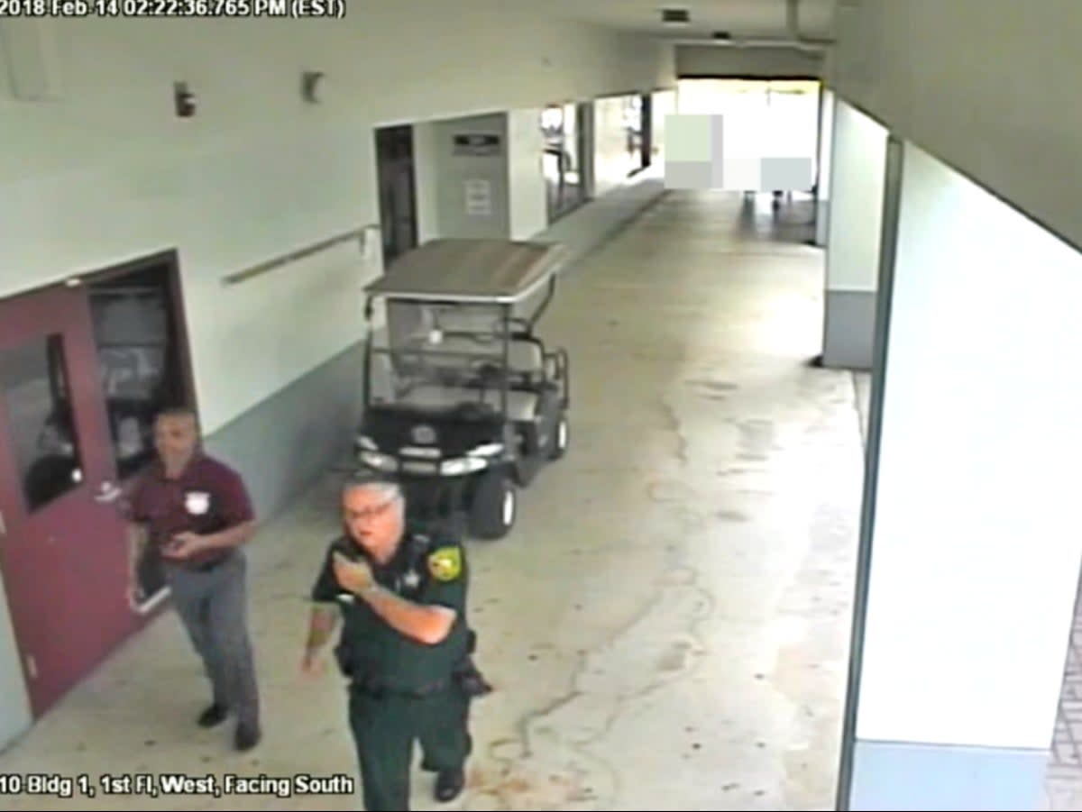 Former Broward County deputy Scot Peterson walking with an unarmed security guard outside Marjorie Stoneman Douglas High School during the Parkland mass shooting (Broward County DA)