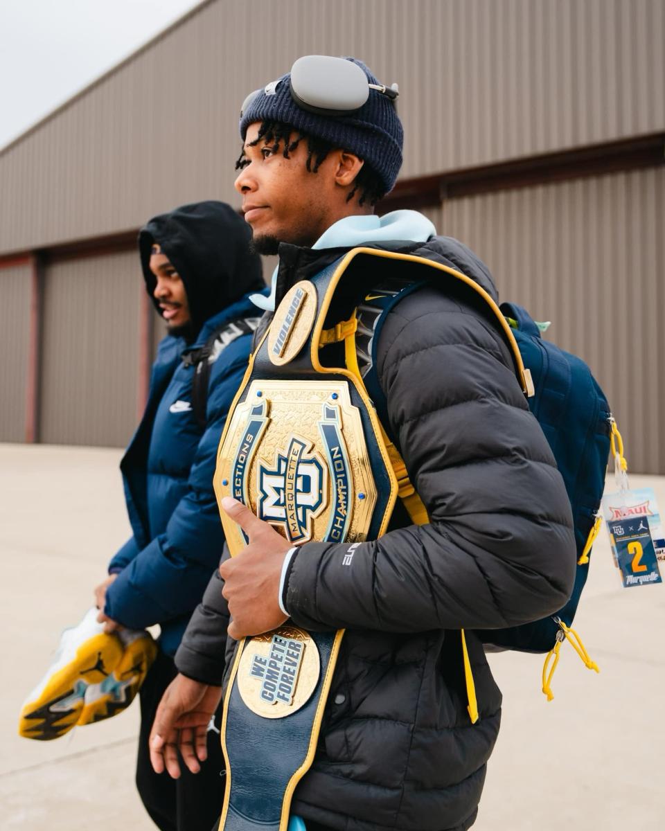 Chase Ross carries Marquette's special Deflection Champion Belt.