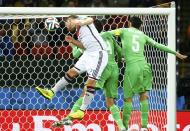 Germany's Shkodran Mustafi (L) jumps to head towards goal during their 2014 World Cup round of 16 game against Algeria at the Beira Rio stadium in Porto Alegre June 30, 2014. REUTERS/Stefano Rellandini