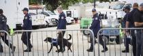 Members of the South Florida Urban Search and Rescue (FL-TF2) walk between the Miami-Dade County operation and media centers during the morning press conference Sunday, July 11, 2021 in Surfside, Fla. Miami-Dade and Surfside mayors updated the media on the overnight and daily operational details after the partial collapse of the Champlain Towers South. (Carl Juste/Miami Herald via AP)