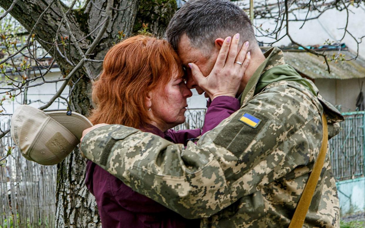 A woman reacts as she says goodbye to her serviceman husband before he leaves to the frontline in Uzhhorod, Ukraine - Serhii Hudak/Reuters 