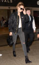 <p>Hadid touched down at LAX in a black bomber jacket, ripped skinny jeans, and black leather booties.</p>