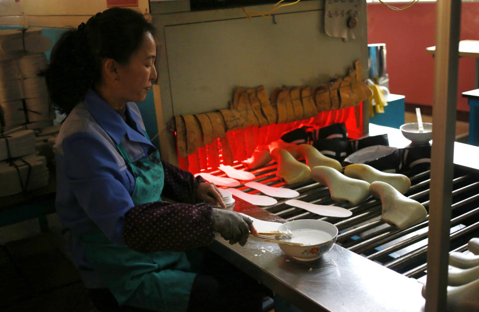 In this Friday, Feb. 1, 2019, photo, a worker tend to her station at Ryuwon Shoe Factory that specializes in sports footwear, in Pyongyang, North Korea. North Korean pop culture, long dismissed by critics as a kitschy throwback to the dark days of Stalinism, is getting a major upgrade under leader Kim Jong Un. The changes are being seen in everything from television dramas and animation programs to the variety and packaging of consumer goods, which have improved significantly under Kim. (AP Photo/Dita Alangkara)