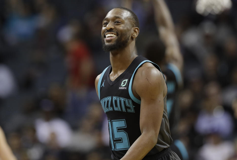 Charlotte Hornets' Kemba Walker (15) reacts after a basket against the Philadelphia 76ers during the second half of an NBA basketball game in Charlotte, N.C., Tuesday, March 19, 2019. (AP Photo/Chuck Burton)