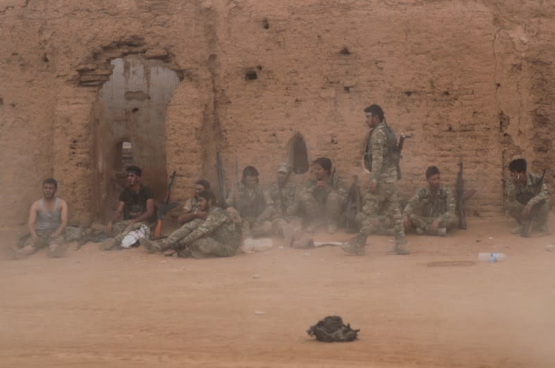 Turkey-backed Syrian rebel fighters gather near the border town of Tal Abyad