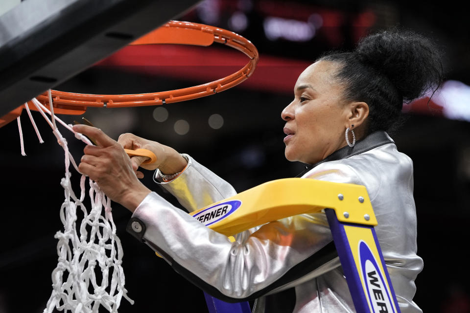 South Carolina head coach Dawn Staley cuts down the net after the Final Four college basketball championship game against Iowa in the women's NCAA Tournament, Sunday, April 7, 2024, in Cleveland. South Carolina won 87-75. (AP Photo/Morry Gash)