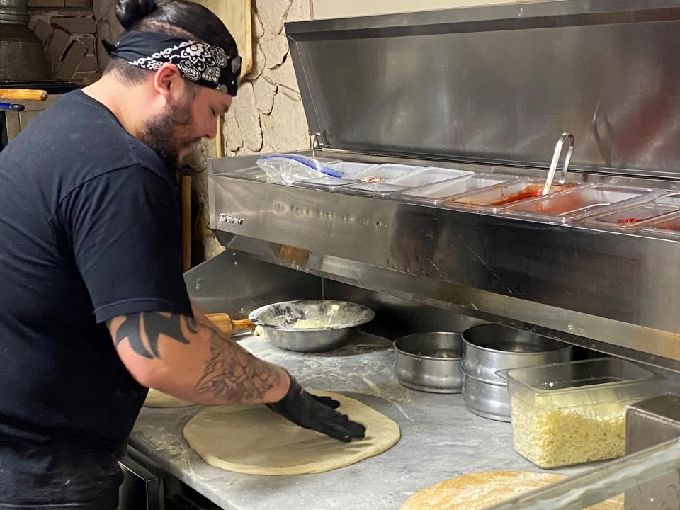 Marcello Segura goes to work on making a pizza at his shop, Grumpy's, located in Saddle Brook.