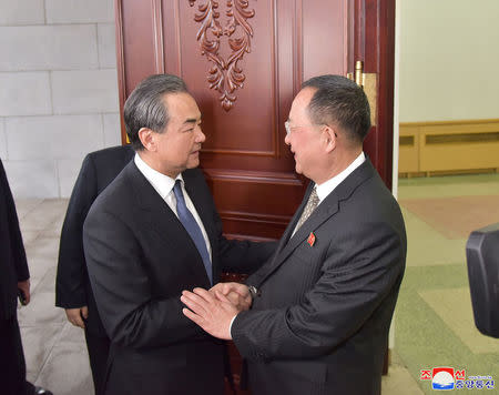 China's state councillor Wang Yi greets North Korea's Foreign Minister Ri Yong Ho in Pyongyang in this photo released by North Korea's Korean Central News Agency (KCNA) in Pyongyang on May 3, 2018. KCNA/via REUTERS