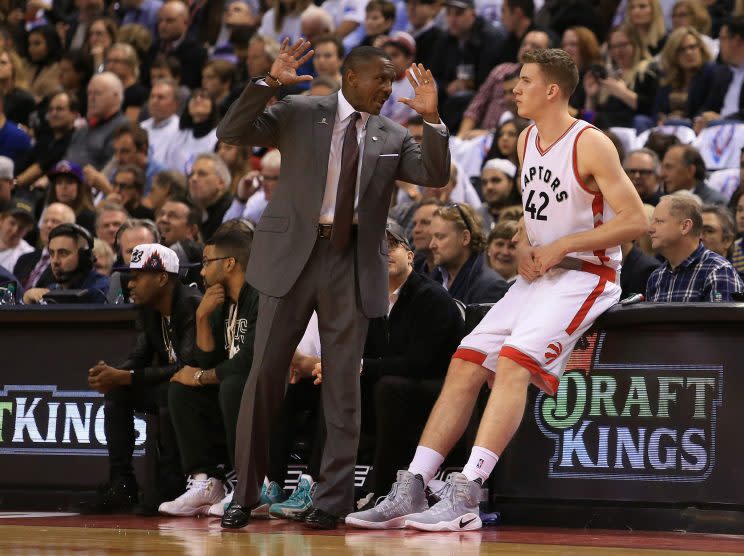 Head coach Dwane Casey of the Toronto Raptors talks to Jakob Poeltl #42 before he makes his debut during the first half of an NBA game against the Detroit Pistons at Air Canada Centre on October 26, 2016 in Toronto, Canada. NOTE TO USER: User expressly acknowledges and agrees that, by downloading and or using this photograph, User is consenting to the terms and conditions of the Getty Images License Agreement. (Photo by Vaughn Ridley/Getty Images)