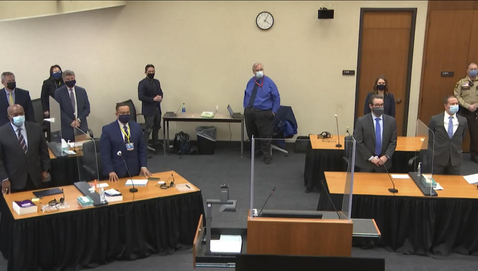 In this image from video, defense attorney Eric Nelson, and defendant, former Minneapolis police Officer Derek Chauvin, both on the right side of the courtroom, arrive for the verdict in Chauvin's trial for the 2020 death of George Floyd, Tuesday, April 20, 2021, at the Hennepin County Courthouse in Minneapolis, Minn. Behind the front table at left is prosecutor Jerry Blackwell, left, and Minnesota Attorney General Keith Ellison. Behind the rear table at left is prosecutor Steve Schleicher, left, and Assistant Minnesota Attorney General Matthew Frank. (Court TV via AP, Pool)