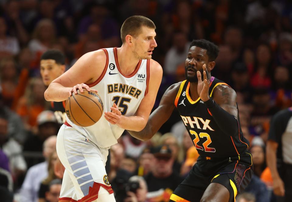 Denver Nuggets center Nikola Jokic (15) against Phoenix Suns center Deandre Ayton (22) in the first half during game three of the 2023 NBA playoffs at Footprint Center in Phoenix on May 5, 2023.