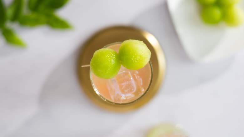 melon ball skewer on top of cocktail 