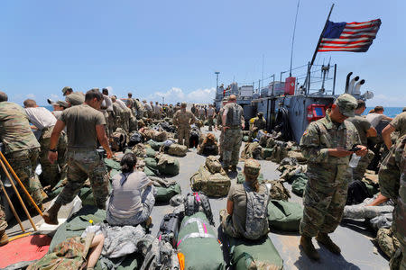 The deck of a U.S. Navy landing craft is crowded with Army soldiers and their belongings as they are evacuated in advance of Hurricane Maria, off St. Thomas shore, U.S. Virgin Islands September 17, 2017. REUTERS/Jonathan Drake