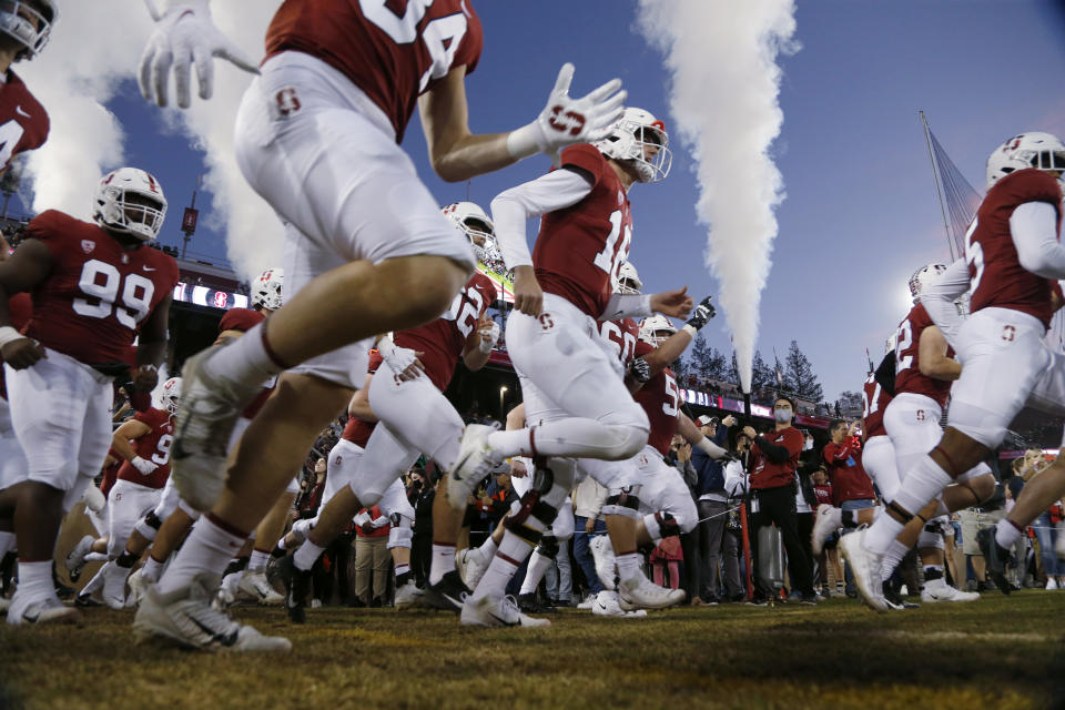 Stanford players run onto the field for the team's NCAA college football game against Notre Dame in Stanford, Calif., Saturday, Nov. 27, 2021. (AP Photo/Jed Jacobsohn)