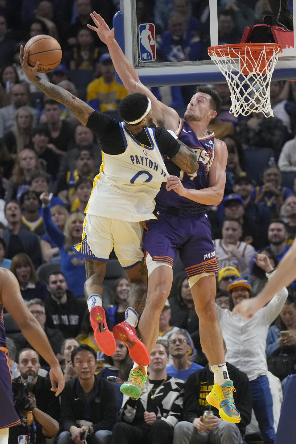 Golden State Warriors guard Gary Payton II (0) shoots against Phoenix Suns forward Drew Eubanks during the first half of an NBA basketball game in San Francisco, Tuesday, Oct. 24, 2023. (AP Photo/Jeff Chiu)