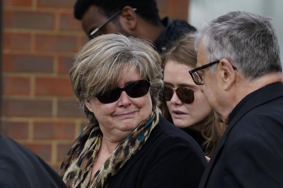 Julia Amess, the widow of Conservative MP David Amess, arrives with friends and family members to view flowers and tributes left for her late husband at Belfairs Methodist Church, where he died after being stabbed several times during a constituency surgery on Friday, in Leigh-on-Sea, Essex, England, Monday, Oct. 18, 2021. A 25-year-old British man with Somali heritage, Ali Harbi Ali, is being held under the Terrorism Act on suspicion of murder in David Amess' killing. Police say the suspect appears to have acted alone and may have had a “motivation linked to Islamist extremism.” (Aaron Chown/PA via AP)