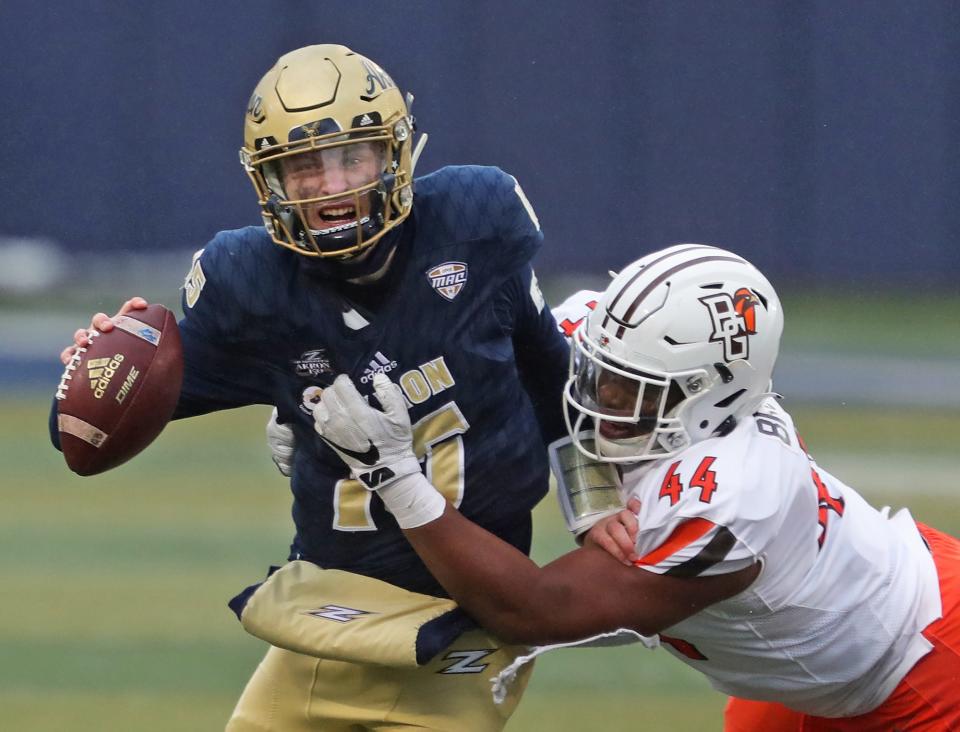 Akron Zips quarterback Zach Gibson (15) is sacked by Bowling Green Falcons defensive lineman Karl Brooks (44) during the first half of an NCAA football game at InfoCision Stadium, Saturday, Dec. 5, 2020, in Akron, Ohio. [Jeff Lange/Beacon Journal]