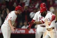 Los Angeles Angels' Luis Rengifo, right, celebrates with Brandon Drury, left, and Taylor Wards, center, after hitting a three-run home run during the sixth inning of a baseball game against the Philadelphia Phillies, Tuesday, April 30, 2024, in Anaheim, Calif. (AP Photo/Ryan Sun)