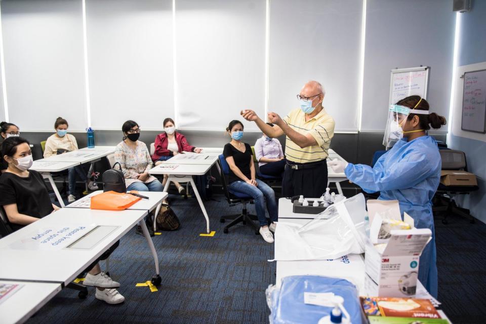 Herbert Phoon Yew Chong teaching a class of volunteers during a training session. (Photo: Ministry of Culture, Community & Youth)