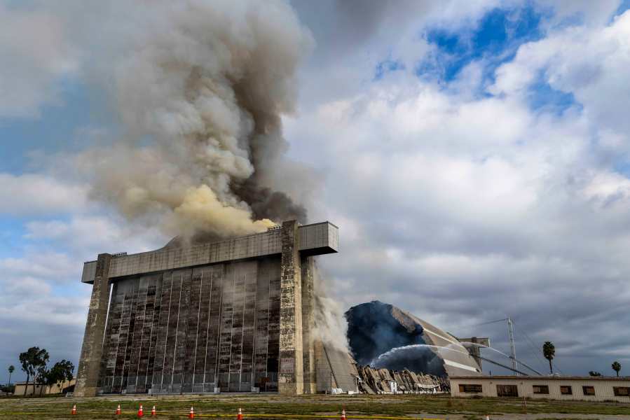 Orange County firefighters battle a fire affecting the north hangar at the Tustin Air Base in Tustin, Calif. Tuesday, Nov. 7, 2023. (Paul Bersebach/The Orange County Register via AP)