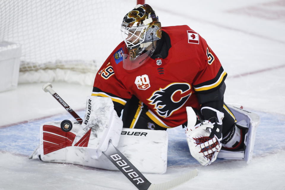 FILE - In this Jan. 28, 2020, file photo, Calgary Flames goalie Cam Talbot deflects a shot during the second period of an NHL hockey game against the St. Louis Blues in Calgary, Alberta. The former Flames goalie signed an $11 million, three-year deal with the Minnesota Wild. (Jeff McIntosh/The Canadian Press via AP, File)