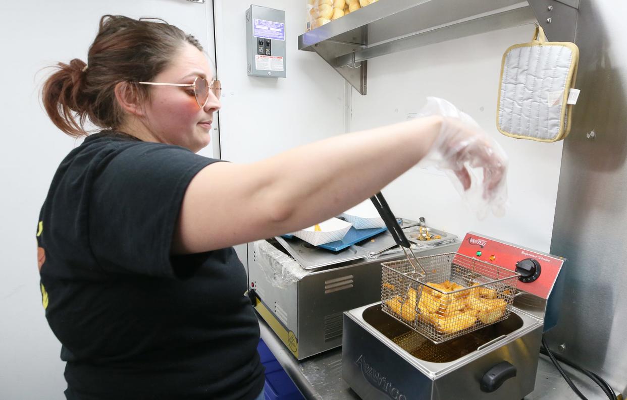 Becca Lydick of The Wiener Guy food truck serves up samples of their jojos during the Ravenna Jo-Jo Festival on Friday.