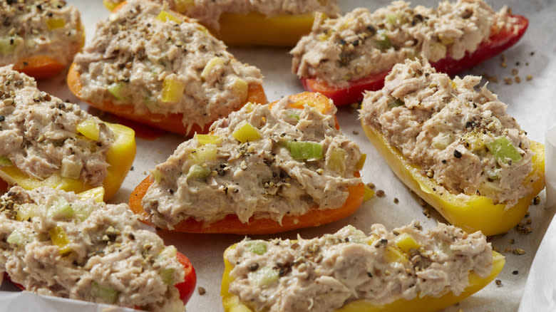 Tuna salad stuffed into orange, red and yellow bell pepper halves