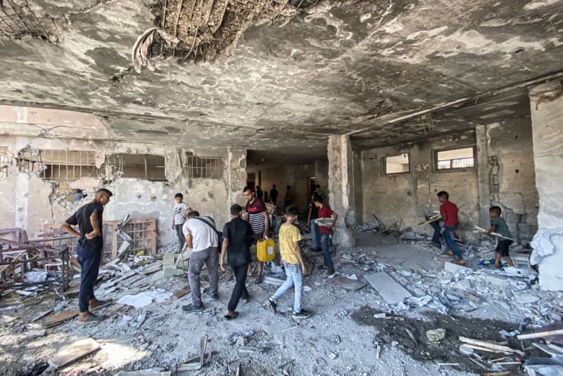 Palestinians inspect the destruction after an Israeli attack on the Al-Zahraa School in the east of Gaza City. Hadi Daoud/APA Images via ZUMA Press Wire/dpa